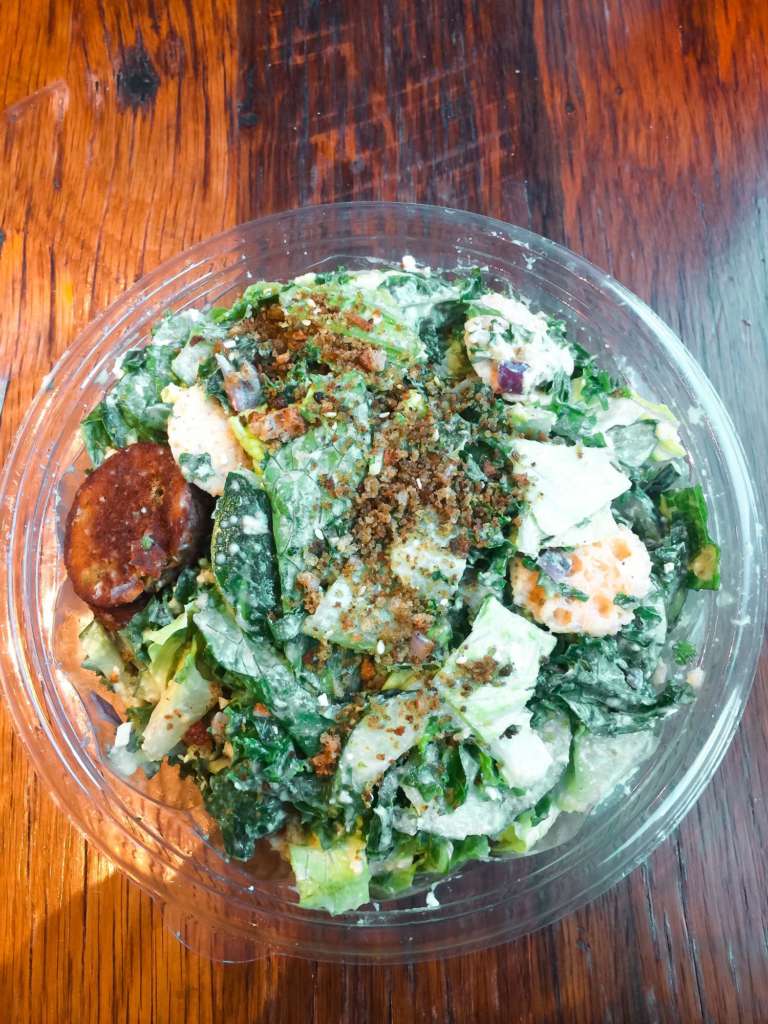 bowl of green salad with falafel and a hummus tahina dressing from sweetgreen